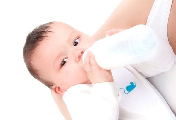newborn eats from a bottle