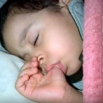 A child sucks his finger in his sleep